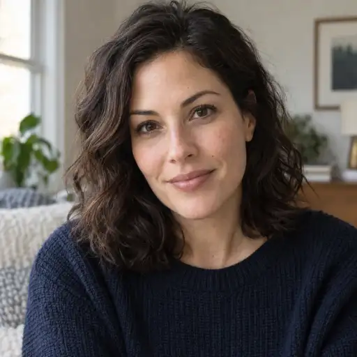 Portrait of a woman with dark hair in a navy top, photographed indoors — Original
